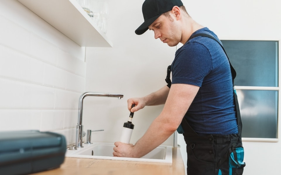 Plumber Working In Sink